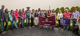 The winning connections of Paint Me Onis accept Mardi Gras Derby stakes trophy on Friday at Louisiana Downs.