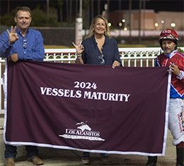 Winning trainer Heath Taylor, Tracy Taylor, and jockey Rodrigo Vallejo accept Empressum's third Vessels Maturity(G1) stakes trophy and blanket.