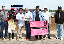The winning connections of Cv Denali accept the Harley Green Derby stakes trophy at Horseshoe Indianapolis on Saturday.