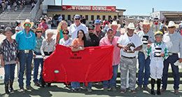 The winning connections Jof Jess No Secret accept the Q-Racing Video Wyoming Distance Challenge stakes trophy on Saturday.