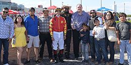 The winning connections of Ab Boogie accept the Cyclone Derby stakes trophy.