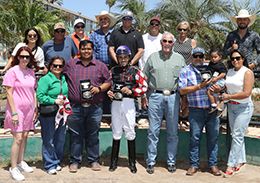 The winning connections of Four Sweet Kid accept the $45,000 AQRA Derby trophy at Turf Paradise on Thursday.