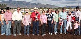 The winning connections of Kj Bad Moon Rising accept the New Mexico State Fair QH Derby stakes trophy on Sunday.