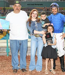 The winning connections of Js Freightrain accept the Rocky Heinzig Stakes trophy at Fair Meadows.