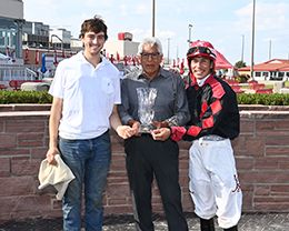 The winning connections of Relentlessly Fast accept the $30,000 Prairie Dash Stakes trophy at Prairie Meadows on Monday.