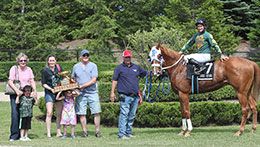 The winning connections of Hawkin The Staw accept the Ontario Bred Derby stakes trophy at Ajax Downs.
