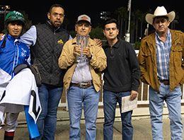 The winning connections of Walking Tool accept the Ah Sigh Handicap stakes trophy in the winner's circle at Los Alamitos Race Course.