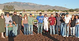 The winning connections of Traxion accept the La Fiesta Futurity stakes trophy at Albuquerque Downs Sunday.