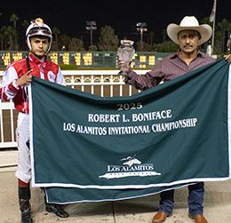 Winning jockey Armando Cervantes and trainer Ramiro Castillo accept the Robert Boniface Los Alamitos Invitational Championship stakes trophy and blanket.