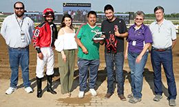 The winning connections of Tres Of Blood accept the $126,000 QHRAI Derby trophy at Horseshoe Indianapolis on Thursday.