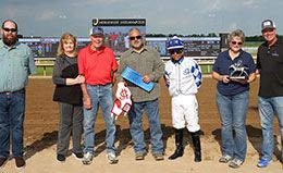 The winning connections of Tachas Secret accept the Braford Stakes trophy at Horseshoe Indianapolis.
