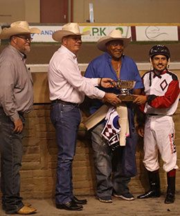 Heritage Place Genearl Manager Spence Kidney presents the winning connections of Work Class Hero the Heritage Place Juvenile stakes trophy on Friday at Remington Park.