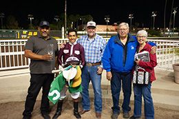 The winning connections of SG Jacob Jay accept the $25,000 James Smith Memorial trophy at Los Alamitos on Saturday.