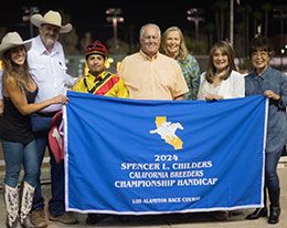 Mark and Maria Winslow present the Spencer Childers stakes trophy to the winning connections of London Toby.