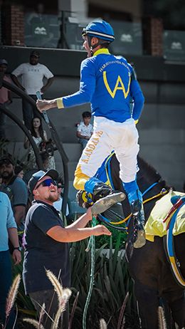 Jockey Ari Andrade celebrates his victory in the Champion of Champions of Brazil.