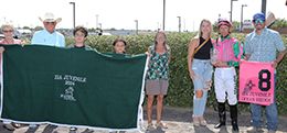 The winning connections of Ocean Bridge accept the $50,000 Zia Futurity trophy at the Downs at Albuquerque on Sunday.