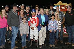 The winning connections of Axel Steel accept the Battle Of The Breeds Claiming Stakes trophy at Lone Star Park Saturday.