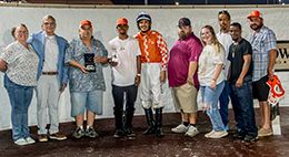 The connections of Mr Pot Scraper accept the $50,000 LQHBA Sale Juvenile Stakes winning trophy at Delta Downs on Saturday.