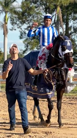 Trainer Kelvin Bispo and jockey Vitor Lima lead Winchester Cartel on the victory lap following his championship triumph.