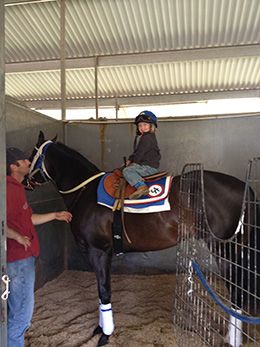 Long before earning the first victory of his riding career, Ryder Olmstead poses aboard AQHA Racing Champion and future All American Futurity sire Hes Relentless.