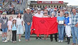 The winning connections of High Flying Cowgirl accept the Gary Waite Maiden Stakes trophy at Wyoming Downs Sunday.