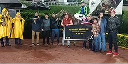 The winning connections of Kc Flyin Jess accept the Garanones Futurity trophy on Sunday.