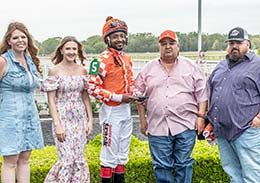The winning connections of Explosive Legend accept the Lip Chip Stakes LLC trophy on Thursday at Louisiana Downs.