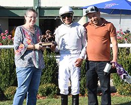 The winning connections of As Moonflash accept the Miss Ellen Stakes trophy at Will Rogers Downs on Sunday.