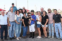 The winning connects of Ajs Favorite Ia accept the Polk County Derby stakes trophy on Saturday.