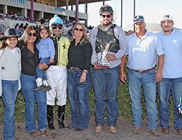 The winning connections of Toastin Heros accept the La Fiesta Derby stakes trophy at Albuquerque Downs Sunday.