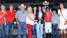 The winning connections of Leavinematthebar accept the Sam Houston 550 Stakes trophy.