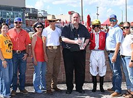 The winning connections of Imma Southern Bell accept the Iowa Stallion Derby stakes trophy at Prairie Meadows.