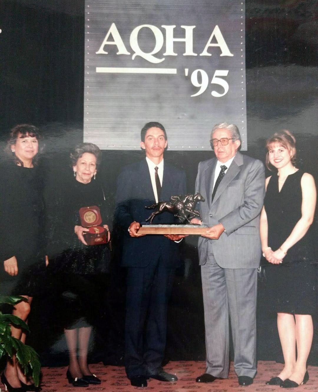 Sinoé Roldán and his grandfather, Héctor Roldán Espinosa, receive the 1995 Champion Two-Year-Old Filly trophy for Shake The Bank.