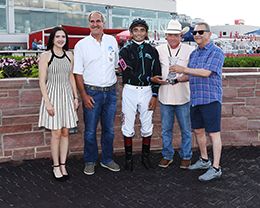 The winning connections of Corona Streakin Jess accept the Cyclone Derby trophy at Prairie Meadows on Sunda.