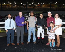 The winning connections of Fire Bolt B accept the $43,478 Q-Racing Video Distance Challenge trophy at Sam Houston on Saturday.
