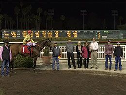 The winning connections of Nymphette accept the Denim N Diamonds Handicap stakes trophy at Los Alamitos Race Course.