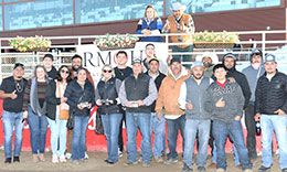 The winning connections of Russel accept the Cherry Creek Futurity stakes trophy Sunday at Arapahoe Park.