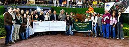 The connections of Rey De Manny celebrate in the winner’s circle.