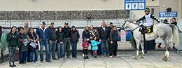 The winning connections of Flight Club accept the CTD Distance #3 Stakes trophy at Century Downs on Saturday.