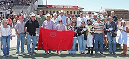 The winning connections of Mv Paint Me Jess accept the Ron Cook Wyoming Bred Futurity stakes trophy.