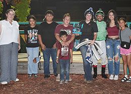 The winning connections of Shy Kisser accept the fifth Belle Stakes trophy at Fair Medows Friday.