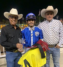 The winning connections of Train B Taka, Roman Figueroa, Edwin Escobedo and Hector Jaramillo accept the Vandys Flash Stakes trophy at Los Alamitos.