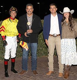 The winning connections of Cd Favorite Lady accept the Downs Fall Quarter Horse Distaff stakes trophy at Albuquerque Downs Saturday night.