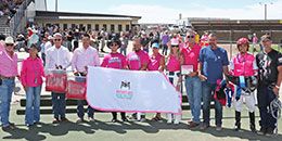 The winning connections of Just A Flyin Cowgirl accept the Raysha's Run - Racing For A Cure Stakes trophy on Saturday at Wyoming Downs.