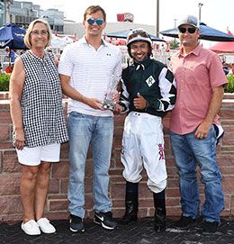 The winning connections of Winnemuca accept the Prairie Meadows Gold Futurity stakes trophy.