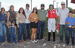 The winning connections of Jess A Bad Lil Cat accept the Rainbow Juvenile stakes trophy Sunday afternoon.