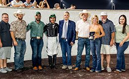 The winning connections of Mamma Im Leaving You accept the Delta Downs Louisiana Bred Oaks stakes trophy.