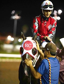 Trainer Ramiro Castillo congratulates jockey Armando Cervantes following Stanley Cartel's easy victory in the Vessels Maturity.