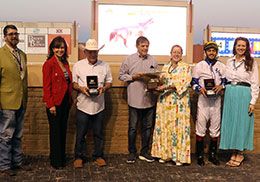 The winning connections of Culrs Joyful Wagon accept the Junos Reward Stakes trophy on Saturday at Remington Park.