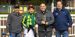 The winning connections Phoebes Baby Girl accept the $20,000 Dashingly Handicap trophy at Los Alamitos on Sunday.